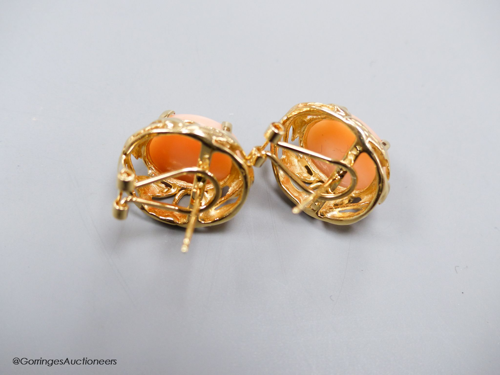 A modern pair of yellow metal (stamped 14k) and oval coral bead earrings, 16mm